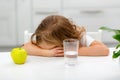 The little girl does not want or refuses to drink water Royalty Free Stock Photo