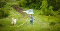 Little girl with dog flying kite Royalty Free Stock Photo