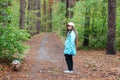 Little girl with dog walking on the road in forest Royalty Free Stock Photo