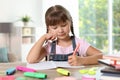 Little girl doing assignment at home Royalty Free Stock Photo