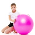 Little girl doing exercises on a big ball for fitness. Royalty Free Stock Photo