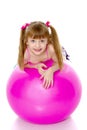 Little girl doing exercises on a big ball for fitness. Royalty Free Stock Photo