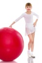 Little girl doing exercises on a big ball for fitness. Royalty Free Stock Photo