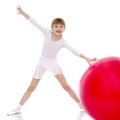 Little girl doing exercises on a big ball for fitness. Royalty Free Stock Photo