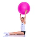 Little girl doing exercises on a big ball for fitness. Royalty Free Stock Photo