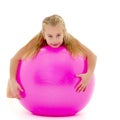 Little girl doing exercises on a big ball for fitness. Royalty Free Stock Photo