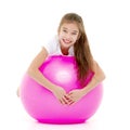 Little girl doing exercises on a big ball for fitness. Royalty Free Stock Photo