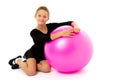 Little girl doing exercises on a big ball for fitness. Royalty Free Stock Photo