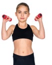 Little girl doing exercises with dumbbells. Royalty Free Stock Photo