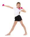 Little girl doing exercises with dumbbells. Royalty Free Stock Photo