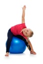 Little girl doing fitness exercise with gym ball. Royalty Free Stock Photo