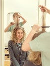 Little girl doing funny hairstyle.