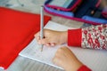 little girl doing her homework. Close-up of hand with pencil learning to write letters. Child writing letter A. First Royalty Free Stock Photo