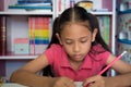 Little girl doing homework on table at home. Royalty Free Stock Photo