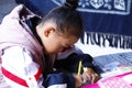 A little girl doing school lessons in Zhoucheng village, Dali, Yunnan, China