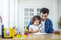 Little girl doing science experiments in the laboratory with father who looks through magnifying glass. Royalty Free Stock Photo