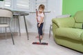 Little girl doing wet cleaning of the floor at home Royalty Free Stock Photo