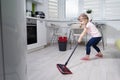 Little girl doing wet cleaning of the floor at home Royalty Free Stock Photo