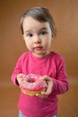 Little girl with donut Royalty Free Stock Photo