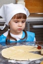 Little girl with a dough