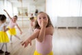 Little girl with down syndrome imitating elephant, having fun during ballet leson at dancing school. Royalty Free Stock Photo