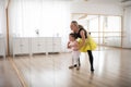 Little girl with down syndrome learning ballet with dance lecteur in ballet studio. Royalty Free Stock Photo