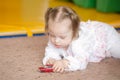 Little Girl with Down syndrome playing car