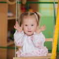 Little girl with Down syndrome playing hide and seek