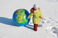 Little girl drags big inflatable globe