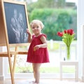 Little girl drawing on blackboard Royalty Free Stock Photo