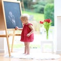 Little girl drawing on blackboard Royalty Free Stock Photo