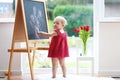 Little girl drawing on blackboard Royalty Free Stock Photo