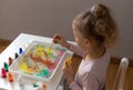 little girl drawing with ebru paints on water Royalty Free Stock Photo