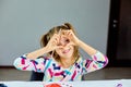 Little girl, drawing at home and make heart from hands Royalty Free Stock Photo