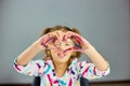 Little girl, drawing at home and make heart from hands Royalty Free Stock Photo