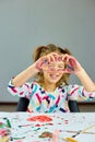 Little girl, drawing at home and make heart from hands Royalty Free Stock Photo