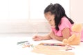 Little girl drawing at home for quarantine durin coronavirus. Kids playing alone at home Royalty Free Stock Photo