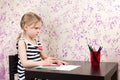 Little girl drawing with pencils at table Royalty Free Stock Photo
