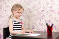 Little girl drawing with pencils at table Royalty Free Stock Photo