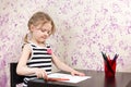 Little girl drawing with pencils at table Royalty Free Stock Photo