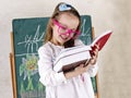 Little girl drawing a picture with chalk on the blackboard Royalty Free Stock Photo