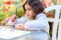 Little Girl Drawing On Stone Outdoors In Summer Sunny Day. Royalty Free Stock Photo