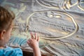 Little girl drawing with their fingers on an interactive sand table. Training master class. Royalty Free Stock Photo