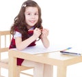 Little girl is drawing using color pencils Royalty Free Stock Photo