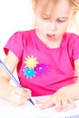 Little Girl Drawing on a White Table Royalty Free Stock Photo