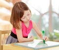 Little girl draws with marker sitting at the table. Royalty Free Stock Photo