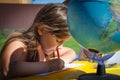 Little girl draws markers outdoors in summer