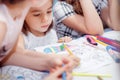 Little girl draws sitting at table in room Royalty Free Stock Photo