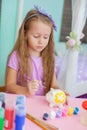 Little girl draws sitting at table in room on her Royalty Free Stock Photo