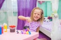 Little girl draws sitting at table in room on her Royalty Free Stock Photo